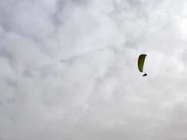 paraglider on cloudy sky photo