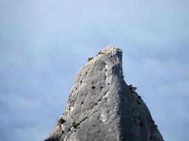 climber on Goloritze rock cliff by the sea Sardinia Italy photo