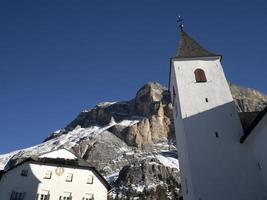 church on Monte croce dolomites badia valley mountains in winter snow panorama photo