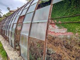 old abandoned greenhouse broken windows photo