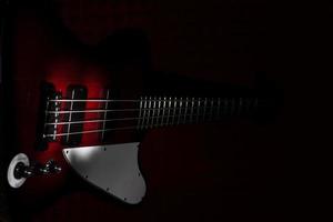 Vintage style electric bass on black background photo