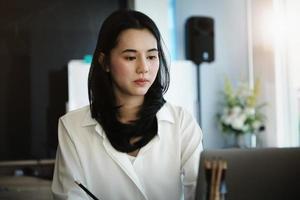 Female employees are working at home through computers to maintain social distancing to reduce the spread of coronavirus. photo