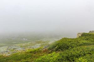 Norway landscape fog clouds rocks cliffs, Veslehodn Veslehorn mountain, Hemsedal. photo