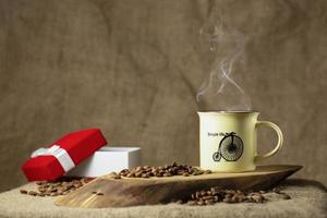 hot cup of coffee on wooden table photo