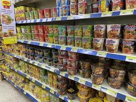 Georgetown, Penang, Malaysia, 2021 - Rows of packet and cup noodles for sale inside a supermarket at Farlim Ayer Itam photo