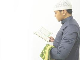 Man Holding and reading quran. Islamic Background photo