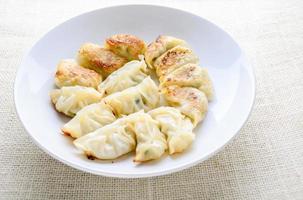 Japanese Fried Dumplings, the half moon-shaped dumplings served in Asian restaurants as an appetiser or side dish, pork and vegetable filling. photo