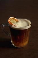 iced orange coffee on wooden table photo