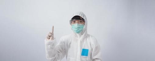 Doctor in PPE suit gesture make hand sign. Represent victory win over virus. photo