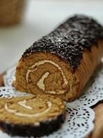 Eye angle view of Mocha roll cake with slice roll cake as a foreground and blurred background. photo