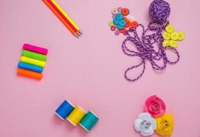 Creative flat lay of hobby time and art tools on a colorful pink background. Copy space photo