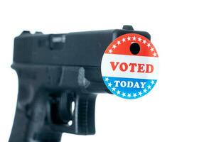 I voted today campaign button with hole on handgun for voter suppression photo