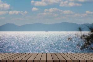 Wooden table tops on the sea floor in the hazy daylight. photo