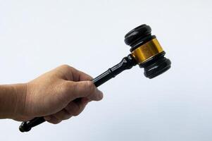 Hand holding Gavel with white background. Law concept photo