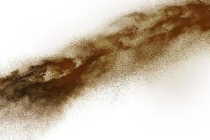 Deep Brown particles splattered on white background. Brown dust splash. photo