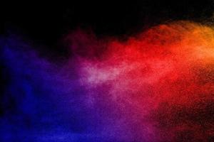 Multi color powder explosion  on black background. photo