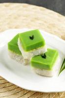 Talam Ketan or Kuih Seri Muka,  Two Layered Dessert with Steamed Glutinous Rice at the Bottom and Green Custard Layer Cake photo