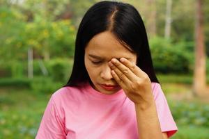 Asian woman having eye pain photo