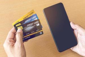 Man holding credit cards and smartphone. On-line shopping on the internet using a smartphone photo