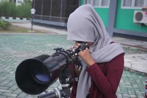 Palangka Raya, Indonesia. March 8, 2017-Students using telescope photo