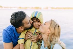 Parents play in the park with their son photo