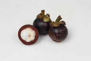 Mangosteen is a tropical fruit from Asia. Mangosteen has a distinctive sweet and sour taste. Mangosteen also has a myriad of benefits, properties, and nutritional content that is useful for health. photo