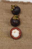 Mangosteen is a tropical fruit from Asia. Mangosteen has a distinctive sweet and sour taste. Mangosteen also has a myriad of benefits, properties, and nutritional content that is useful for health. photo