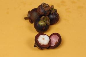 Mangosteen is a tropical fruit from Asia. Mangosteen has a distinctive sweet and sour taste. Mangosteen also has a myriad of benefits, properties, and nutritional content that is useful for health. photo