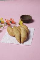 Chocolate bananas from raw materials covered with rolls of pastry dough sheets. Molen bananas with pastries are usually served with a cup of hot coffee or tea. Focus blur photo