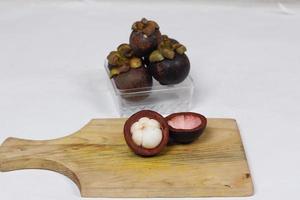 Mangosteen is a tropical fruit from Asia. Mangosteen has a distinctive sweet and sour taste. Mangosteen also has a myriad of benefits, properties, and nutritional content that is useful for health. photo