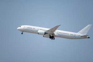 A commercial airplane taking off at an airport. photo