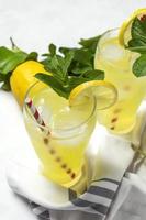 Fresh Lemonade or mojito cocktail with lemon, mint and ice photo