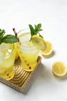 Fresh Lemonade or mojito cocktail with lemon, mint and ice photo