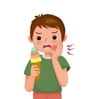 Cute little boy with sensitive teeth has a toothache while eating cold ice cream touching his cheek and feel aching vector