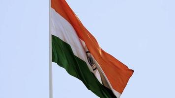 India flag flying high with pride in blue sky, India flag fluttering, Indian Flag on Independence Day and Republic Day of India, tilt up shot, waving Indian flag, Flying India flag video