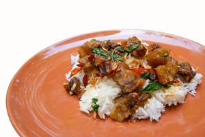 Most favorite and popular street food or homemade food of Thailand, Crispy pork belly with stir fried basil top on rice. It has a spicy, salty, sweet taste. Isolated white background. photo