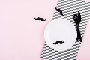 Table setting on Fathers day with cutlery and mustache . Happy Fathers day. Background of fathers day. photo