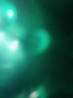 Abstract green shiny blur background with shiny particles and different elements in close up photo