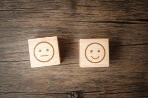 emotion face symbol on wooden blocks. mood, Service rating, ranking, customer review, satisfaction, evaluation and feedback concept photo