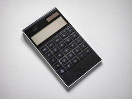 High-angle shot of a calculator isolated on a white background photo