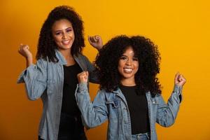 Two beautiful afro friends hugged, concept of best friends and sisters. photo
