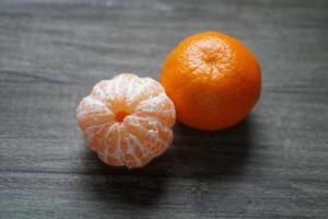 clementines or tangerines or mandarin oranges on rustic wooden table photo