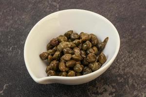 Tasty capers in the bowl photo