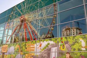 Round ferris wheel spins fast at colorful day photo