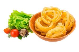 Tagliatelle in a bowl on white background photo