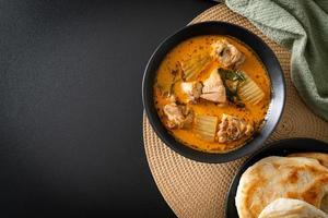 Chicken curry soup with roti photo