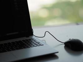 notebook with mouse on the table photo