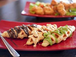 croffles on a red plate with lots of flavors and toppings photo