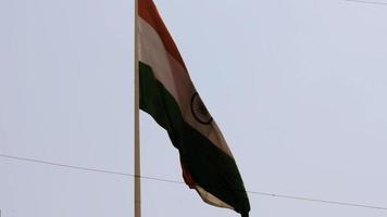 India flag flying high with pride in blue sky, India flag fluttering, Indian Flag on Independence Day and Republic Day of India, tilt up shot, waving Indian flag, Flying India flags video