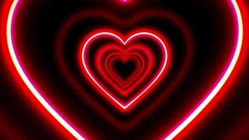 Animation red neon light hearts shape on black background. video